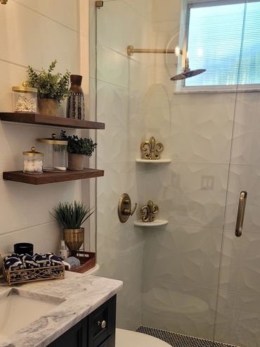 Shower niche with floating shelves and marble-look tile