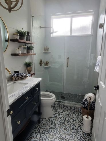 Compact bathroom with modern vanity and walk-in shower
