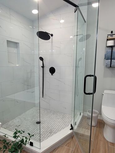Walk-in glass shower with matte black hardware