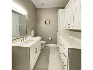Bright white bathroom with double vanity and quartz countertops
