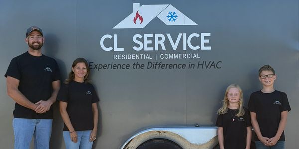 Family standing in front of CL Service HVAC trailer on a sunny day.