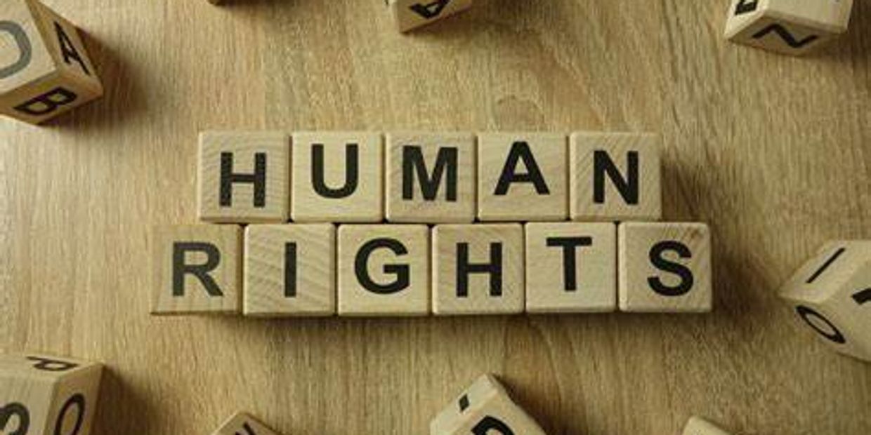 Scrabble letters spelling HUMAN RIGHTS with other letters scattered around.