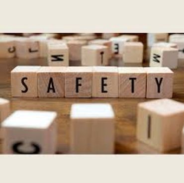 Scrabble letters on spelling SAFETY with other letters scattered around.