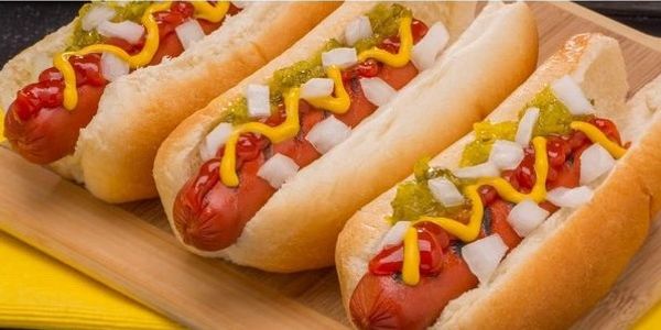 Hot dogs with ketchup, mustard, relish, and onions