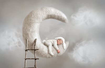 Newborn baby boy on moon prop.  Oklahoma city newborn photography.  Edmond newborn photography.