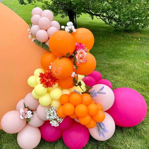 Pink, orange, yellow balloon cluster with flowers
