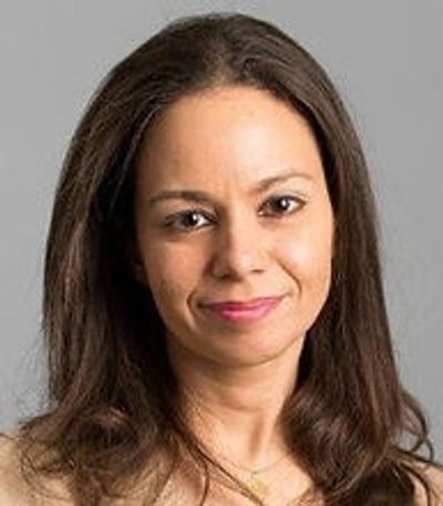 Portrait of a woman with long brown hair and a gentle smile.