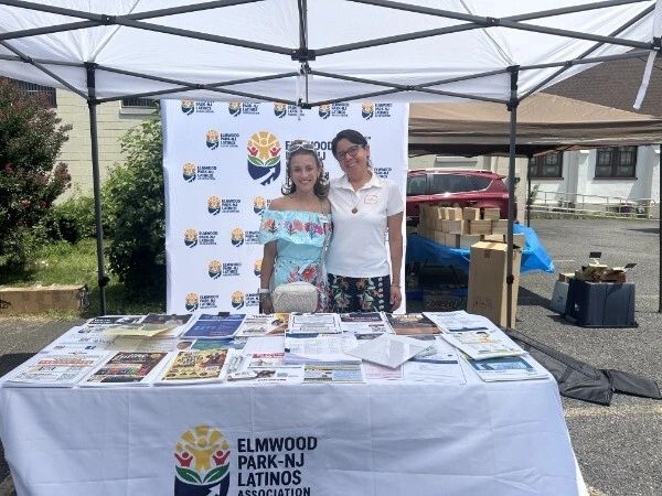 Two women at Elmwood Park-NJ Latinos Association booth.