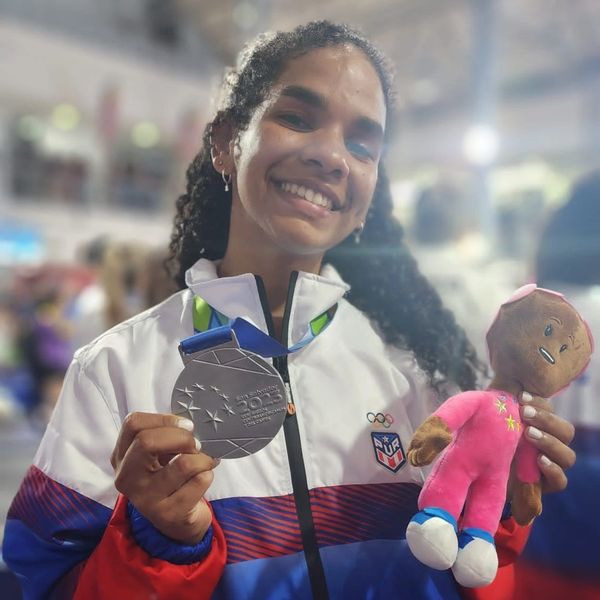 Alicia Penzo holding a Basket ball Medal