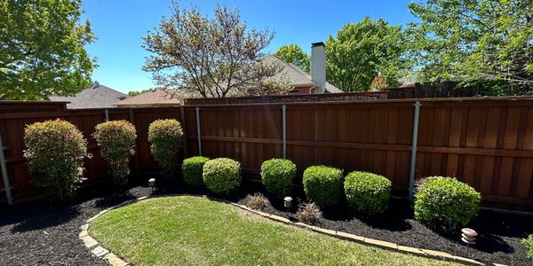 Flower bed clean up and mulch installation along with shrub trimming