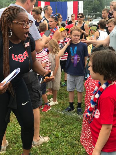 Coach Lisa Morgan gives advice to young runners before the 4th of July races. 
