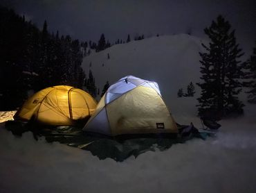 Two small tents at night in the snow on Mt. Hood