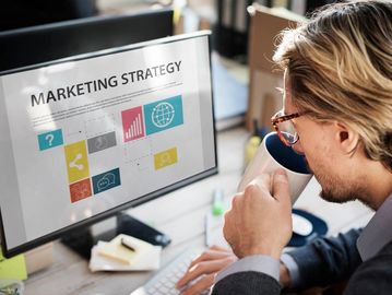 A marketing virtual assistant developing a marketing strategy while drinking in his cup