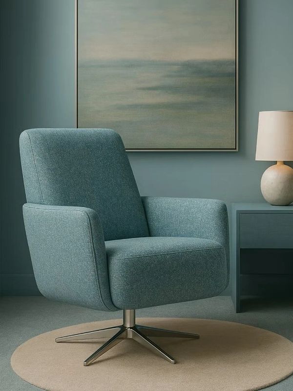 Modern teal swivel chair in a stylish room.