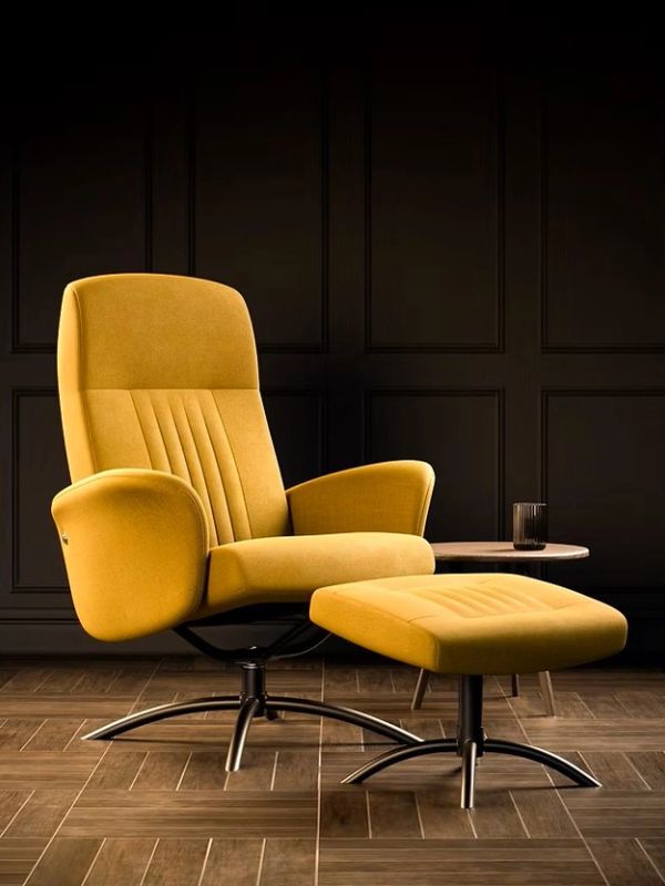 Modern mustard yellow armchair with footrest and side table.