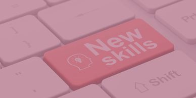Keyboard with a red key labeled 'New skills' symbolizing learning and growth.