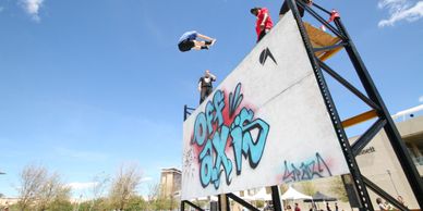 Parkour athletes doing trampoline wall tricks
