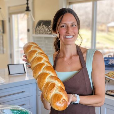The chef behind Seven Loaves, Kaitlyn Johnson, presenting a challah loaf for an Easter brunch celebration.