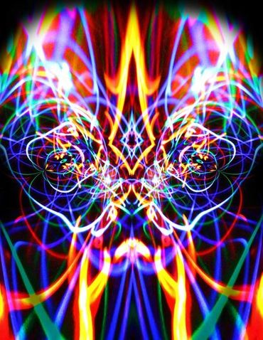 Colorful neon light patterns forming a symmetrical abstract face.