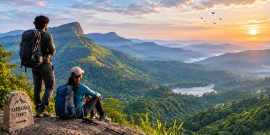 Two hikers enjoying a scenic sunrise view over lush green hills.