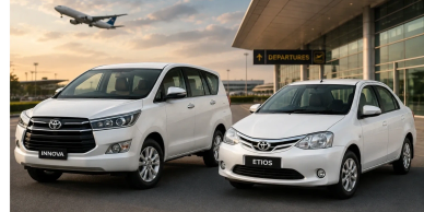 Two white Toyota cars parked near an airport.