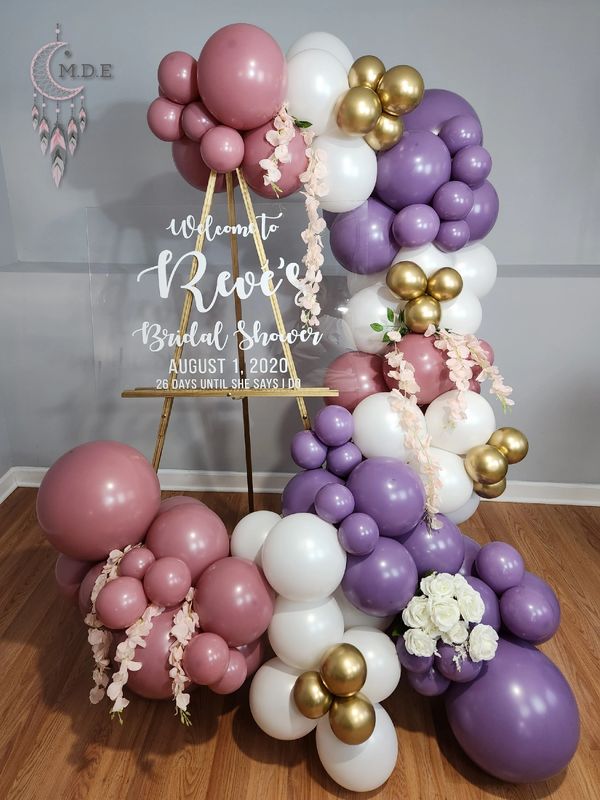 Custom welcome sign with 6ft organic balloon garland plus deluxe silk flowers and chrome balloons.
