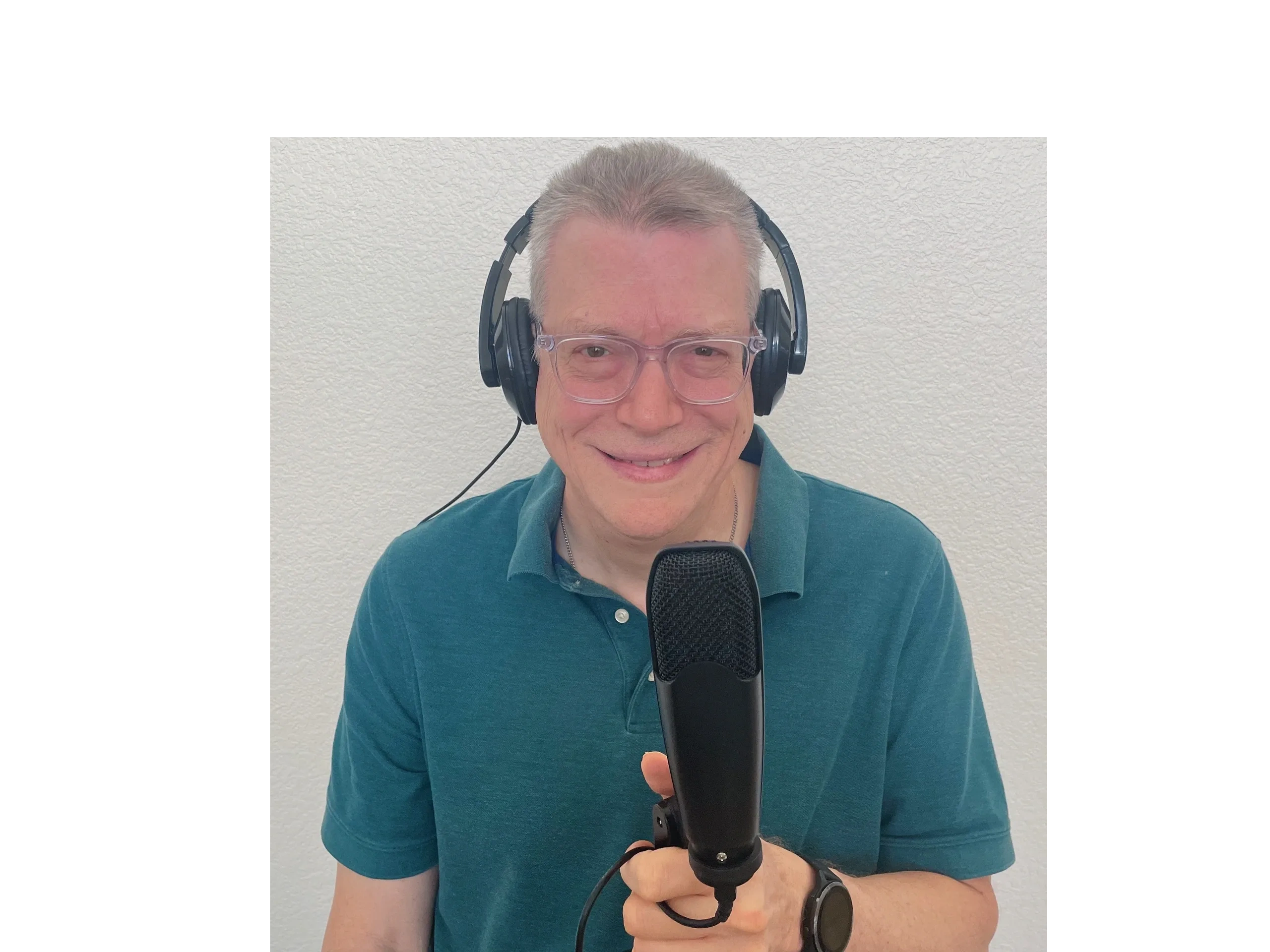 Jim Weisbecker, podcast host, smiling with headphones and microphone.