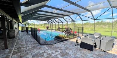 A Removable Mesh Life Saver Pool Fence allows the family to safely enjoy their pool and patio area.