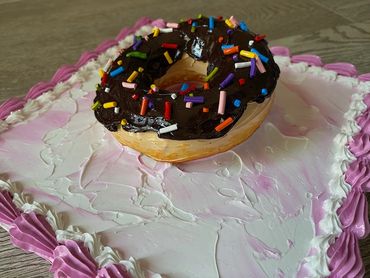 Close-up White cake with Chocolate frosting on a pink square canvas