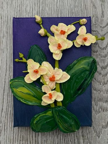 A painting of white orchids with orange centers and green leaves on a dark purple canvas.