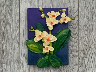 A painting of white orchids with orange centers and green leaves on a dark purple canvas.