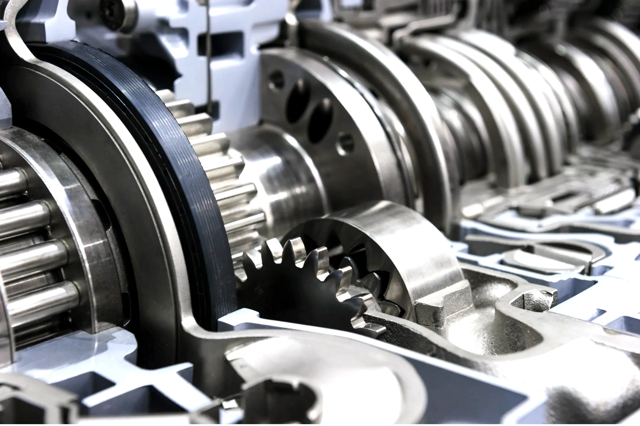 Close-up of shiny metal gears inside a mechanical engine.