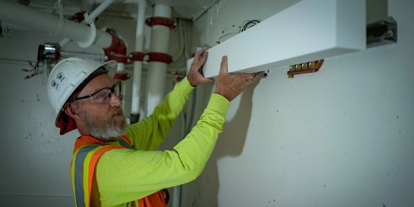 Journeyman Electrician installing electrical lighting fixture