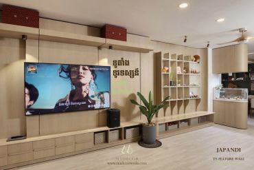 Japandi style TV feature wall with shelving and plant.