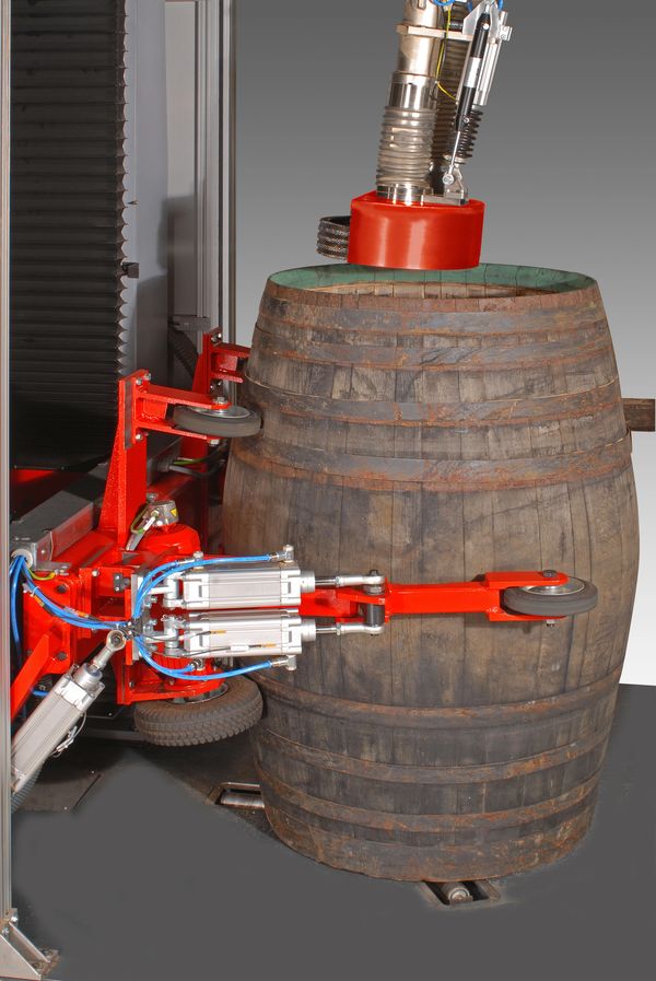 Cask, barrel in skiving machine for rasping. Preparing cask and barrel for re-charring.