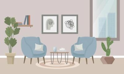 Cozy modern living room with blue chairs and abstract art.