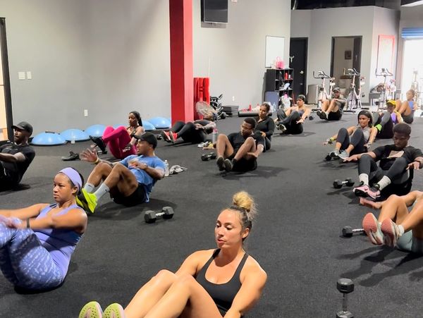 Group fitness class doing floor exercises.