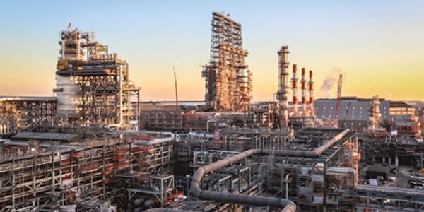 Industrial refinery complex at sunset.