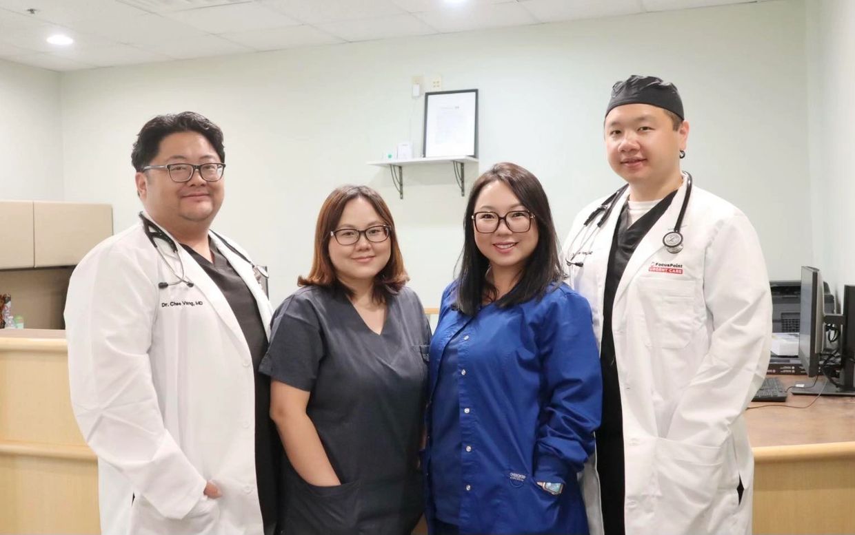 Four healthcare professionals posing together in a medical office.