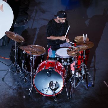 a musician with red drums he is a drummer