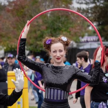 a hula Hooper with a purple and black costume