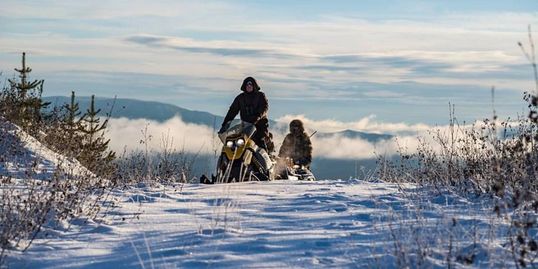 Snowmobile riding in winter wilderness adventure free and wild nature 