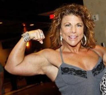 A woman wearing a sleeveless gray shirt