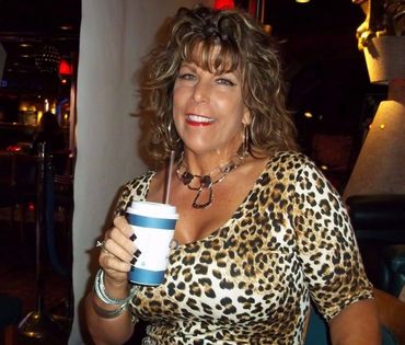 A woman holding a cup of beverage