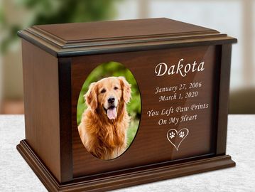A wooden pet memorial urn featuring a framed pet photo and engraved name and dates, offering a perso