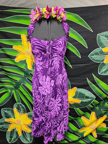 Purple floral dress with a tropical flower crown on a mannequin.