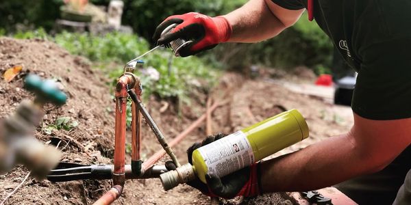 plumber repairing a copper yard line