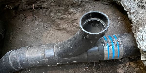 repair of a lacking sewer drain underneath a foundation