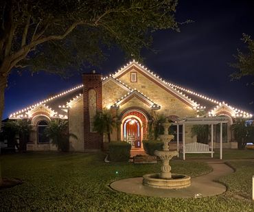 Warm white Christmas lights on front roof lines and ridges.