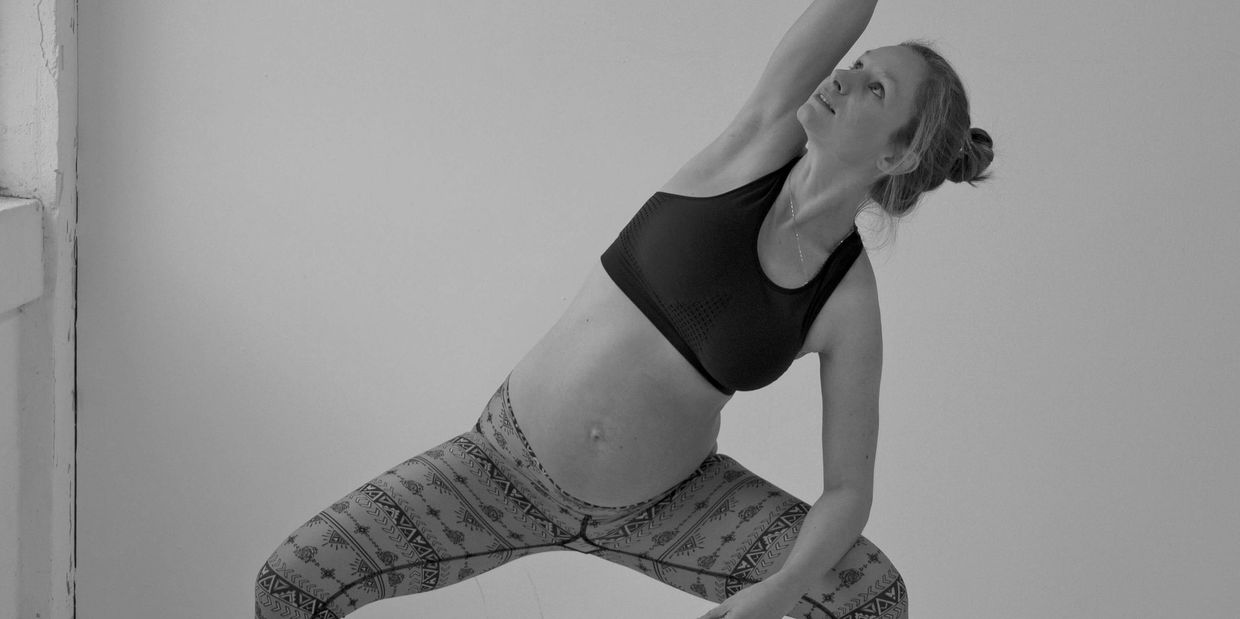 Picture of Rose from The Birthing Well practicing pregnancy yoga